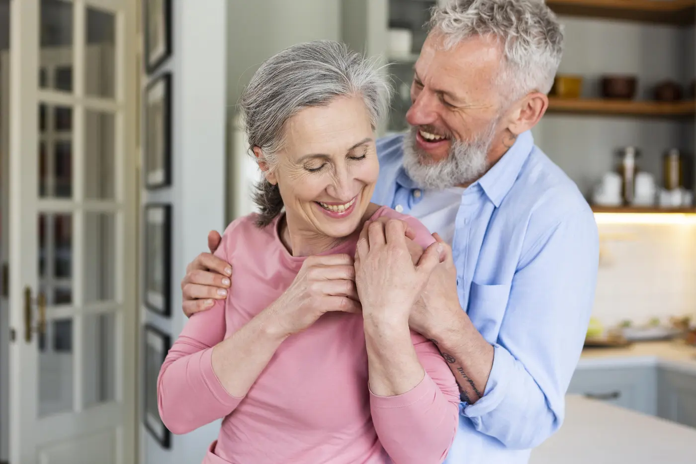 A senior couple smiling after affordable dental care